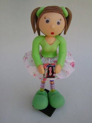Boneca com revista na mão