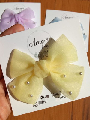 Laço em tule amarelo com pérolas